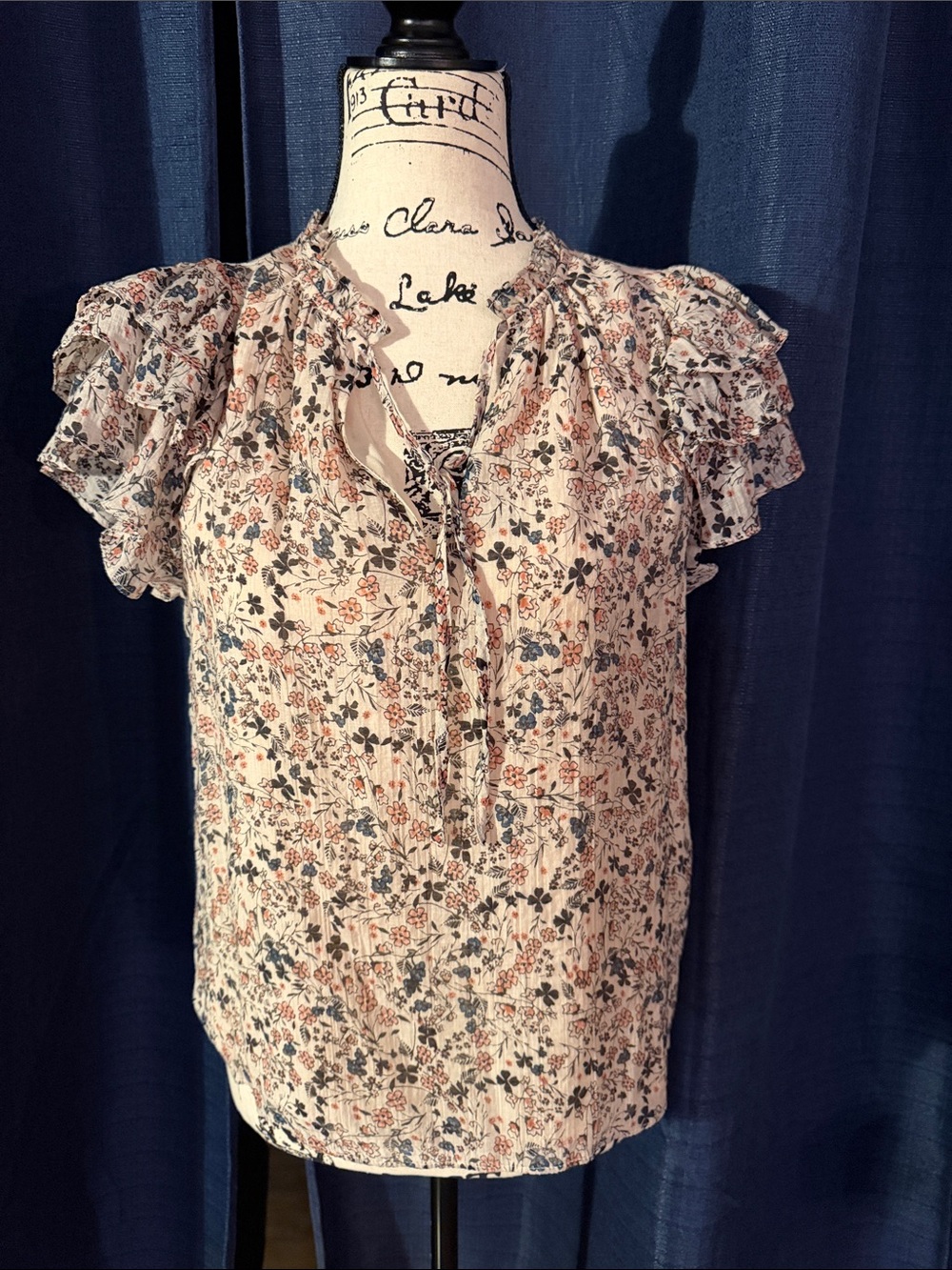1. State Cream Floral Tie-Neck Blouse with Blue and Rust Accents